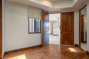 Unfurnished bedroom featuring wood-type flooring