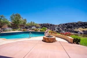 View of swimming pool featuring an outdoor fire pit and a patio area