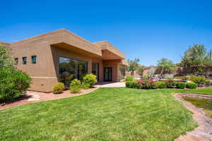 Rear view of house featuring a yard