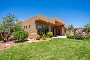 Rear view of property with a lawn