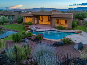 View of swimming pool with a mountain view and a patio