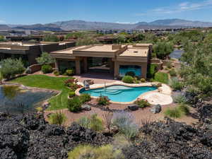 View of pool with a mountain view and a patio area