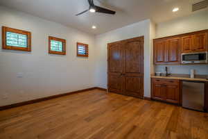 Kitchen featuring ceiling fan, light hardwood / wood-style floors, sink, and appliances with stainless steel finishes