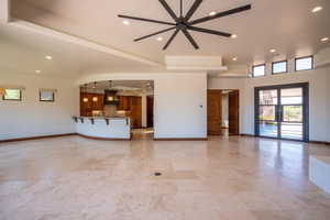 Unfurnished living room with french doors, ceiling fan, and sink