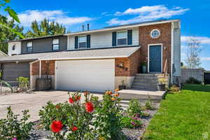 Front of property featuring a garage and a front lawn