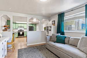 Living room with hardwood / wood-style floors and a textured ceiling