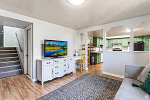 Living room with hardwood / wood-style floors and a textured ceiling