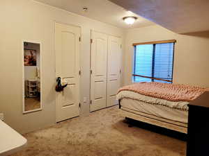 Carpeted bedroom with a textured ceiling