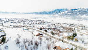 Snowy aerial view featuring a mountain view