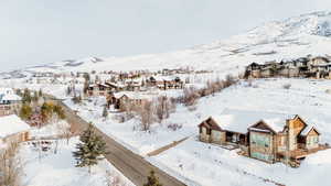 Snowy aerial view featuring a mountain view