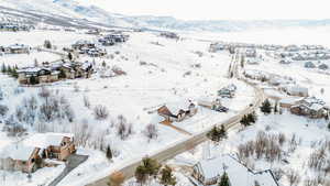 Snowy aerial view featuring a mountain view