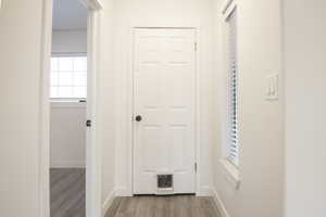 Hallway with light hardwood / wood-style floors