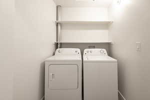 Clothes washing area featuring washer and clothes dryer