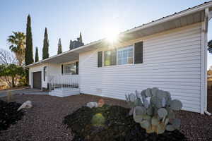 View of front of house featuring covered porch and a garage