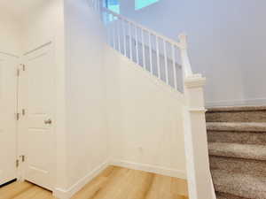 Stairs featuring hardwood / wood-style floors