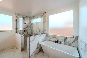 Bathroom featuring separate shower and tub