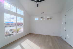 Unfurnished room with ceiling fan and light hardwood / wood-style flooring