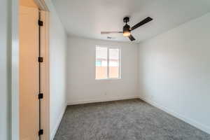 Unfurnished room featuring carpet flooring and ceiling fan