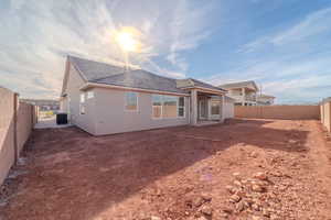 Rear view of house with central AC