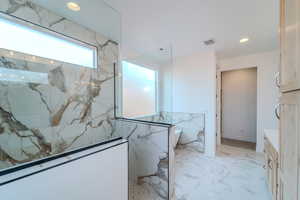 Bathroom with a shower and vanity