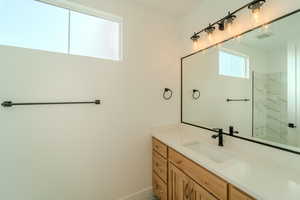 Bathroom with a tile shower and vanity