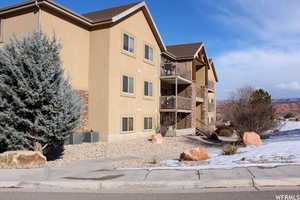 Snow covered property with cooling unit