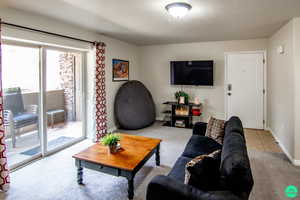 Carpeted living area featuring baseboards