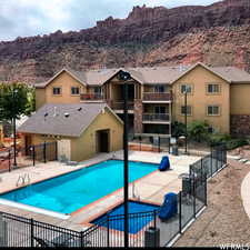 View of swimming pool with a mountain view and a patio