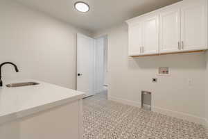 Laundry area with cabinets, washer hookup, electric dryer hookup, and sink