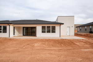 Rear view of property featuring central AC and a patio