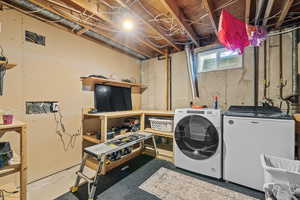 Laundry room with washer and clothes dryer