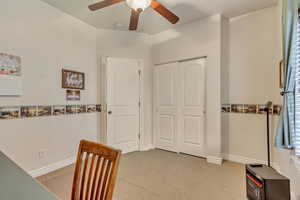 Carpeted office space featuring ceiling fan