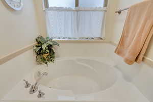 Bathroom featuring a tub to relax in