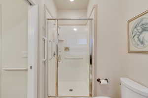 Bathroom with toilet and a shower with door