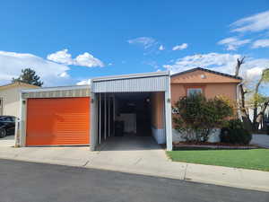 Garage featuring a carport