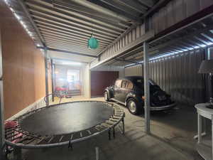 Garage with wood walls and a trampoline