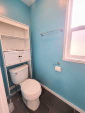 Bathroom with tile patterned floors and toilet