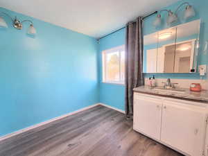 Bathroom featuring hardwood / wood-style flooring and vanity