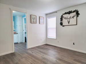 Spare room with dark wood-type flooring