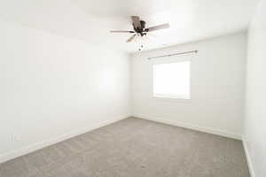 Empty room with ceiling fan and carpet