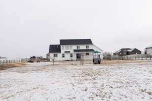 View of snow covered rear of property