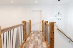 Hallway featuring a notable chandelier and light wood-type flooring