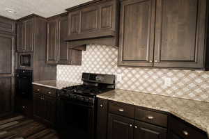 Kitchen featuring dark brown cabinetry and black appliances