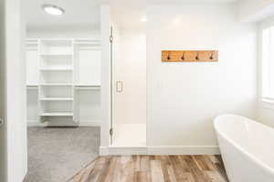 Bathroom with plus walk in shower and wood-type flooring