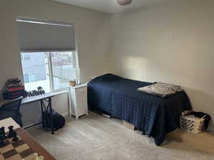 Carpeted bedroom with ceiling fan