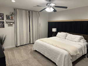 Bedroom featuring ceiling fan and light colored carpet