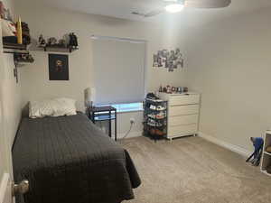 Carpeted bedroom with ceiling fan