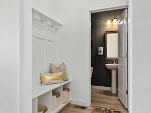 Mudroom with light hardwood / wood-style floors