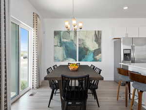 Dining room featuring light hardwood / wood-style flooring and a chandelier