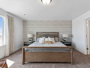 Bedroom featuring light colored carpet